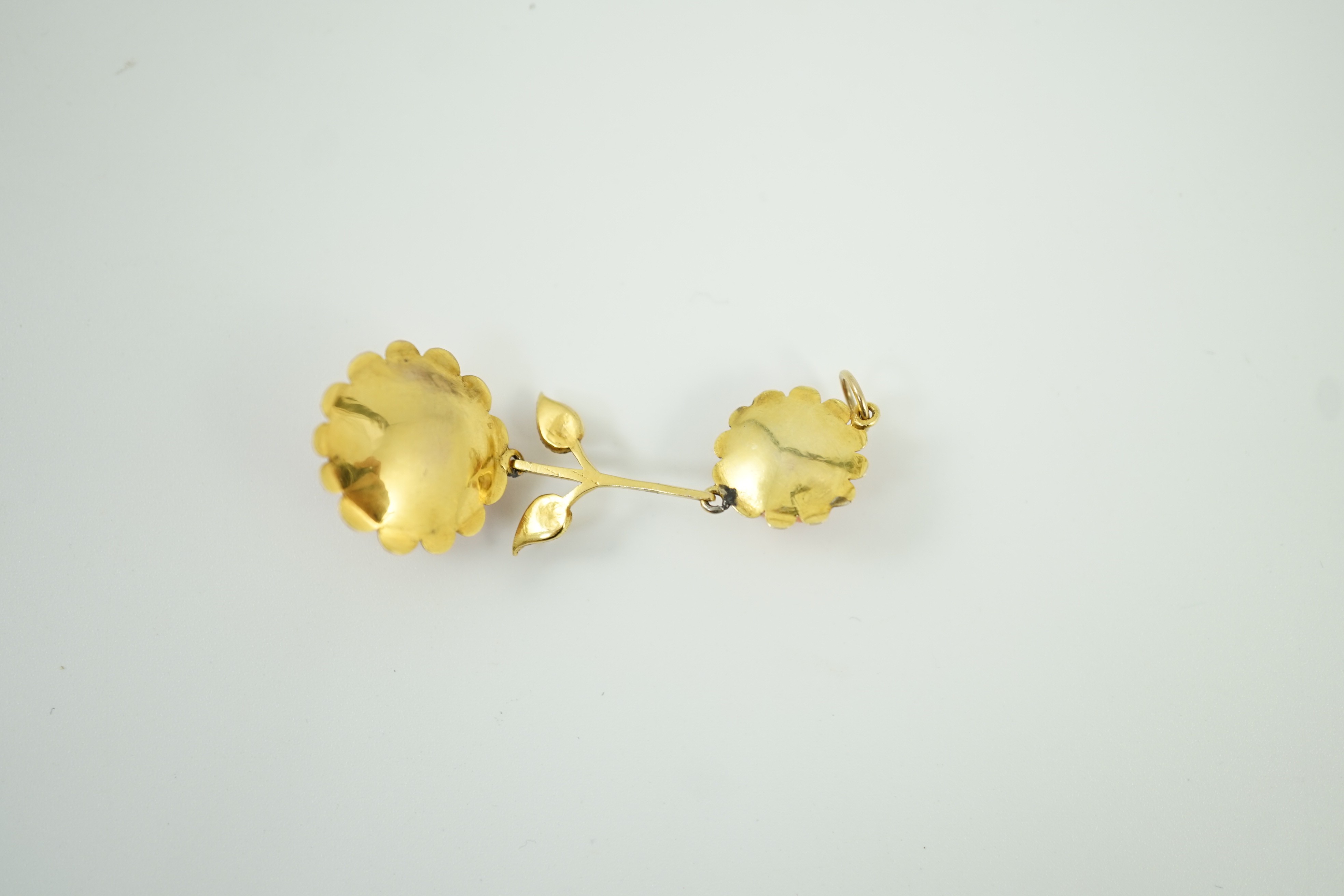 A yellow metal and two stone carved coral set 'rose' drop pendant, overall 57mm, gross weight 6 grams.